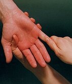  Photo of therapist massaging client's hand