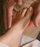  Photo of hands massaging client's foot 